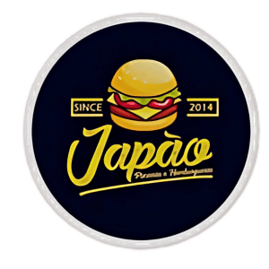 Pizzaria gama, imagem da logo, circulo de fundo preto com a imagem de um hambúrguer e o nome japão em amarelo
